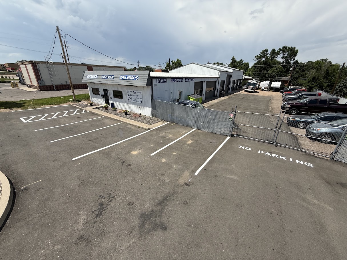 Freshly striped parking stalls and NO PARKING lettering at an auto repair shop