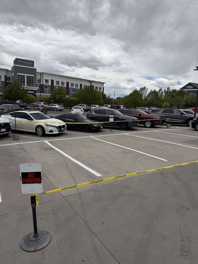 Crisp white parking stall lines on a new concrete lot