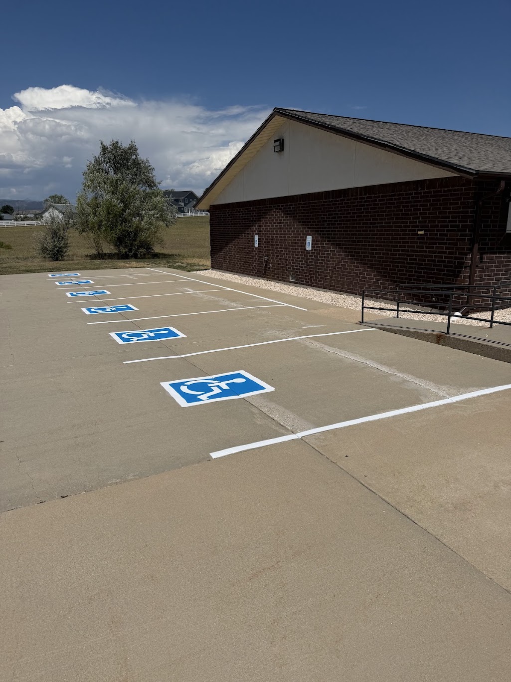 Blue ADA accessibility symbols painted in accessible parking stalls